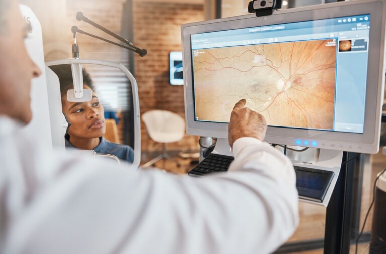 Doctor and patient looking at retinal scan